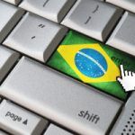 Business concept mouse cursor pressing Brazil enter key on metallic keyboard